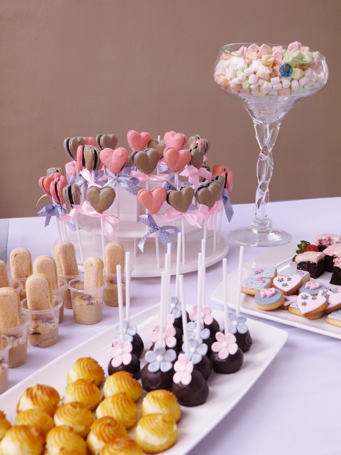 Macaron and cake pops, profiteroles, tiramisu, decorated cookies, brownies, and marshmallows